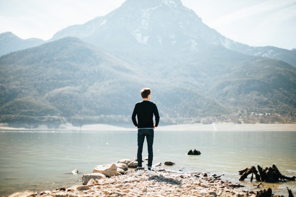 man standing on front of lake at daytime